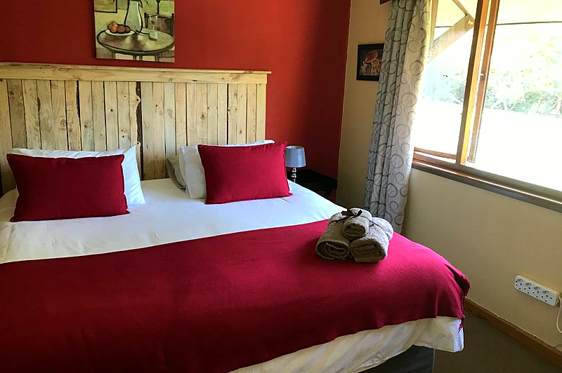 Wild Pomegranate room with king bed and warm forest views