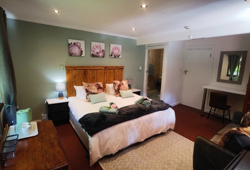 Forest Buzzard garden room with sage green walls and protea artwork